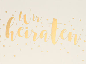 Detailaufnahme der goldenen Schrift und der Konfettis.